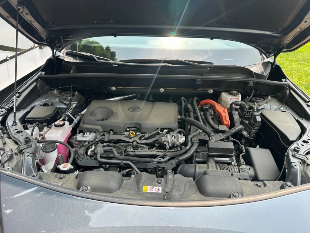 Dirty engine bay before professional detailing in Stoneham MA – built-up grease and dust