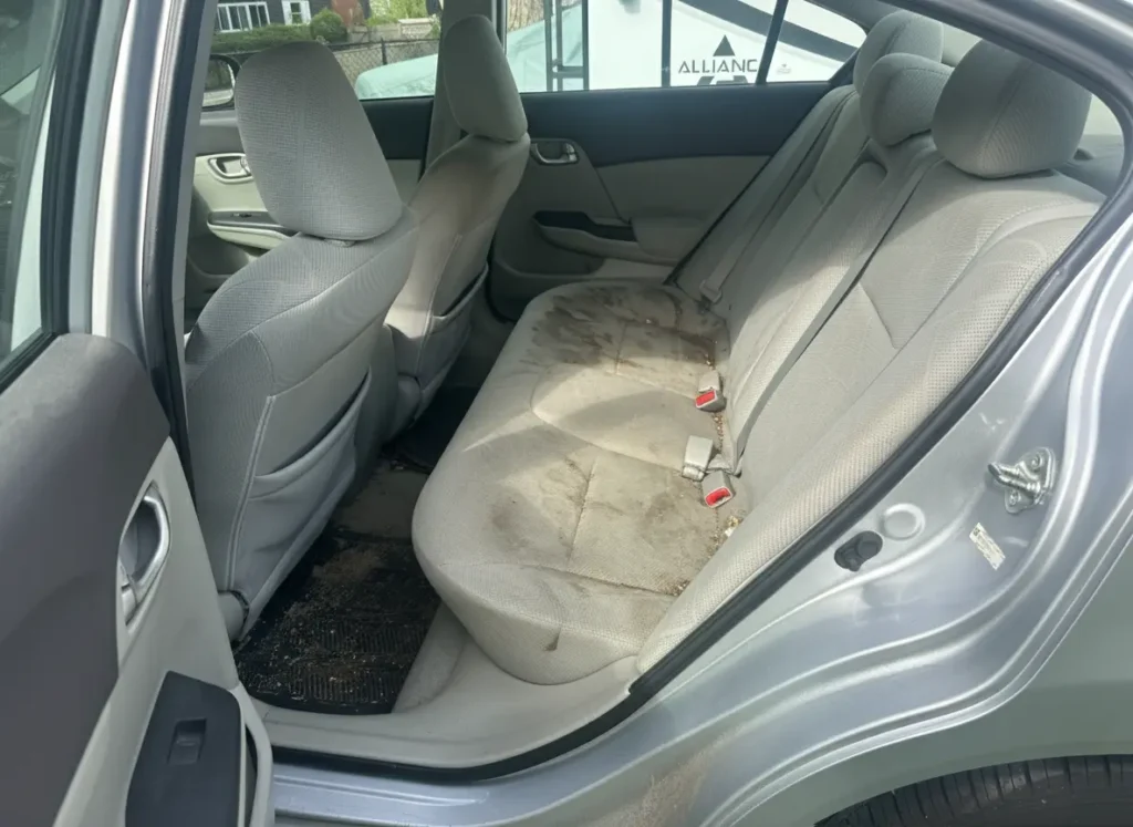Dirty rear seat before interior detailing in [tmc_town] MA