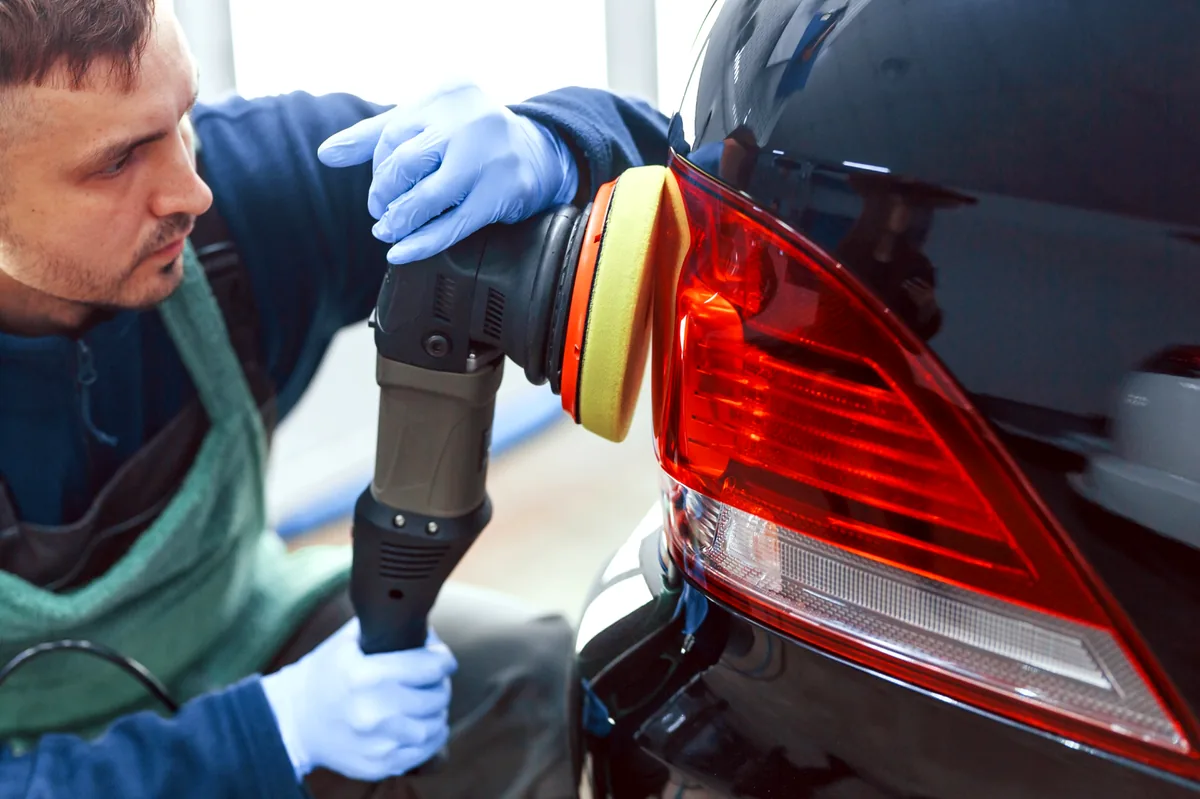 Auto detailing technician performing paint correction in [tmc_town] MA