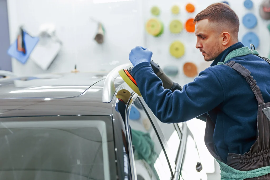 Why choose TMC Detailing for paint correction in [tmc_town] MA — technician carefully polishing vehicle