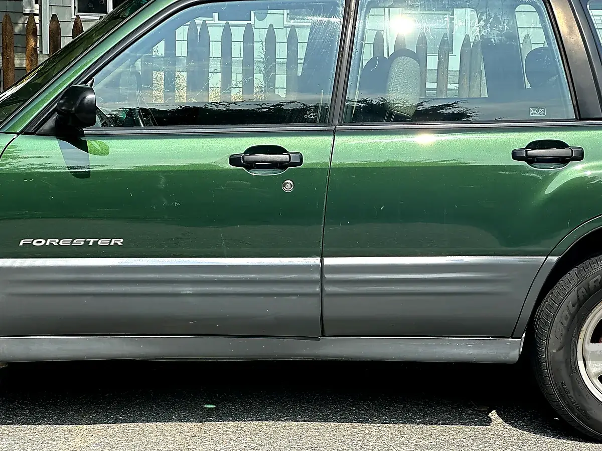 Green SUV with faded gray plastic trim before restoration – Stoneham MA