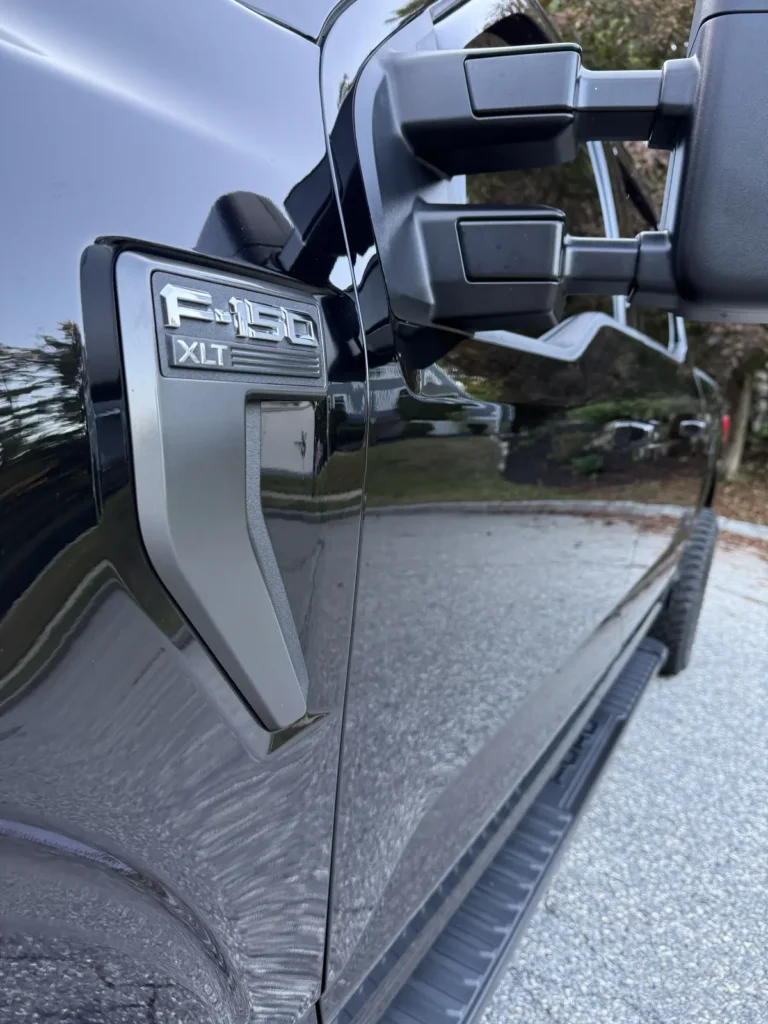 Close-up of ceramic coated Ford F-150 badge with high gloss reflection